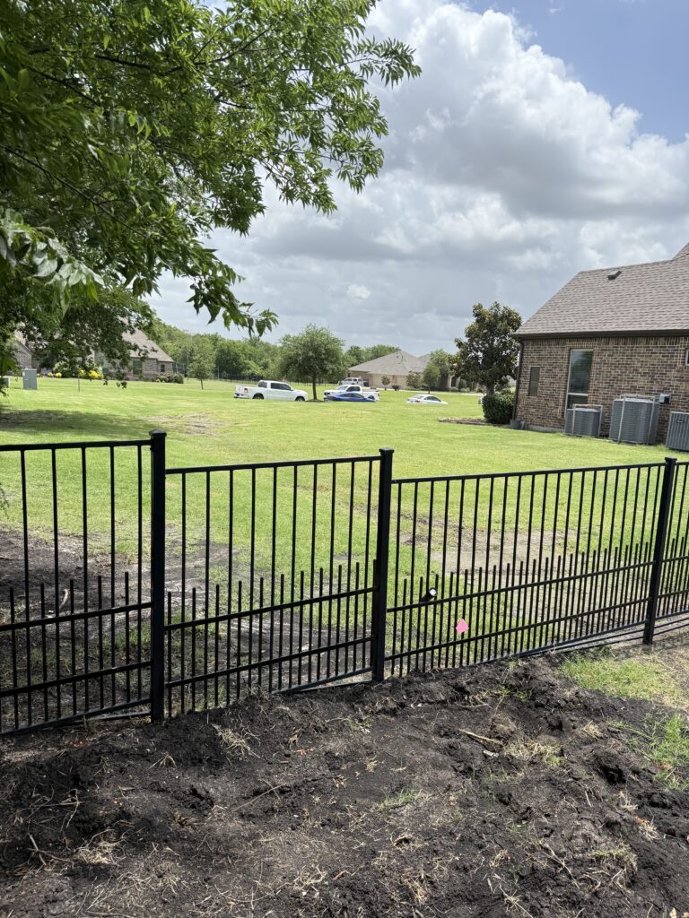 Custom black ornamental metal railing installed