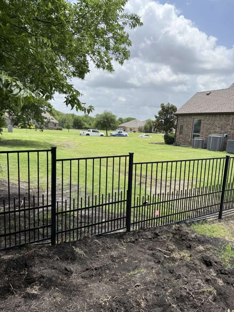 Custom black ornamental metal railing installed